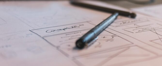 two black pens on white paper